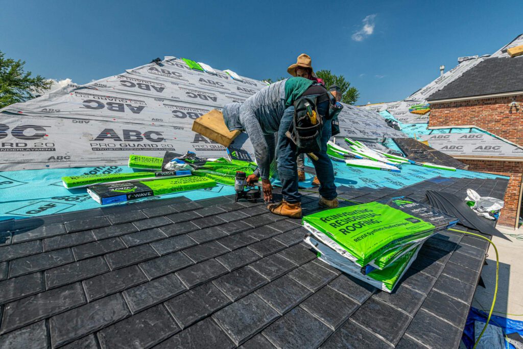 Roofing crew installing new roofing materials on a residential home during roof replacement in Lancaster.